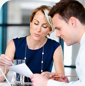 a man and woman looking at papers