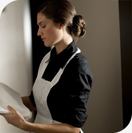 a woman in an apron holding a book